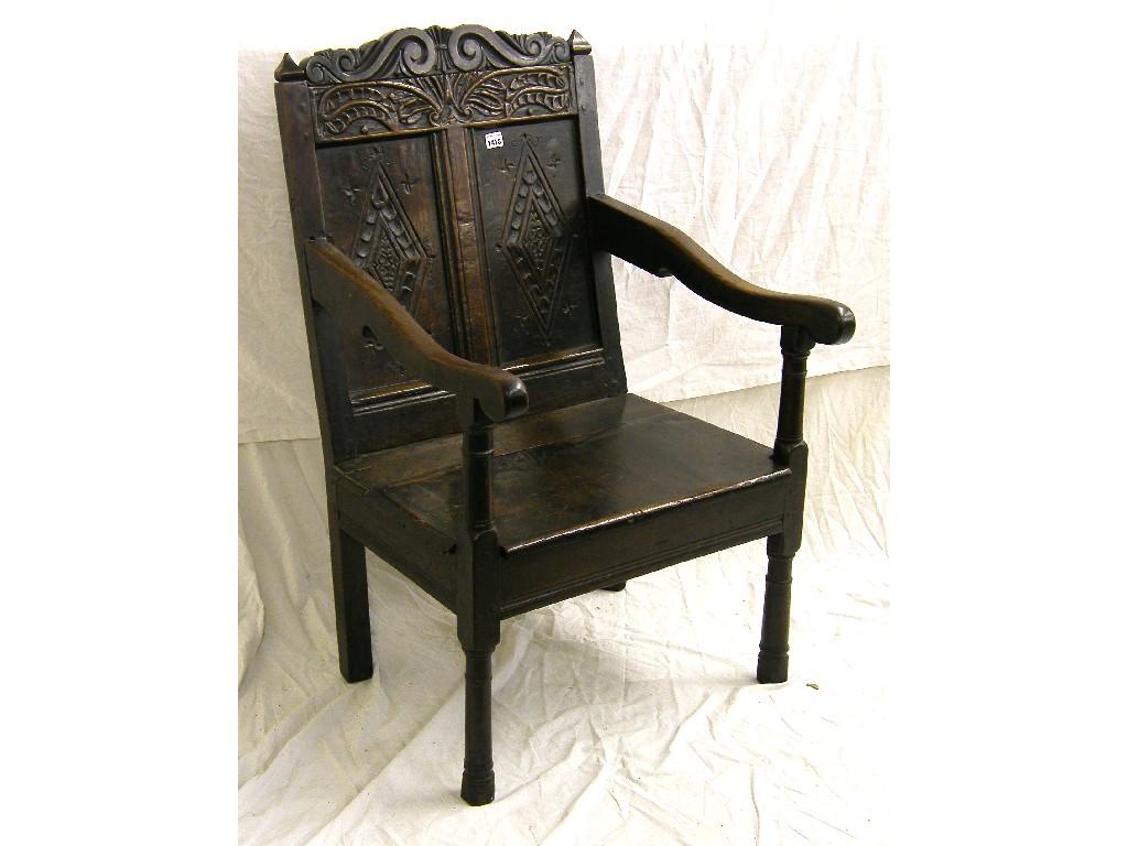 Appraisal: Antique elm wainscot type armchair the foliate carved cresting rail