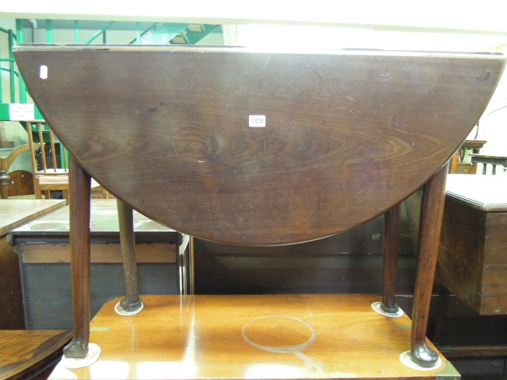 Appraisal: A Georgian mahogany oval drop leaf dining table raised on