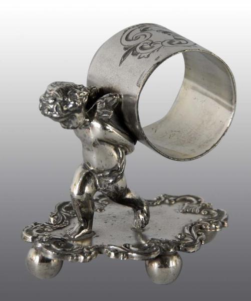 Appraisal: Winged Cherub Holding Figural Napkin Ring Description Boubor Silver Co