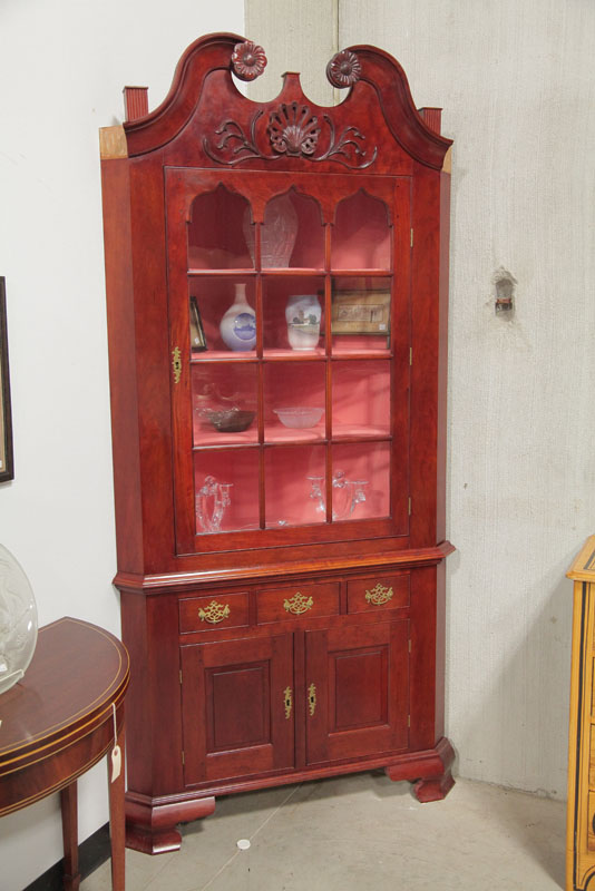 Appraisal: REPRODUCTION CORNER CUPBOARD Mahogany having a broken arch pediment with