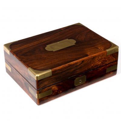 Appraisal: A Victorian rosewood and brass bound dressing case with countersunk