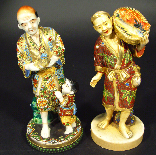 Appraisal: Two Japanese Satsuma pottery figure groups a gentleman clutching a