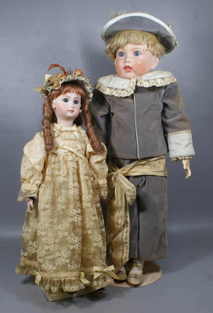 Appraisal: Reproduction French Bisque head dolls the larger of which is