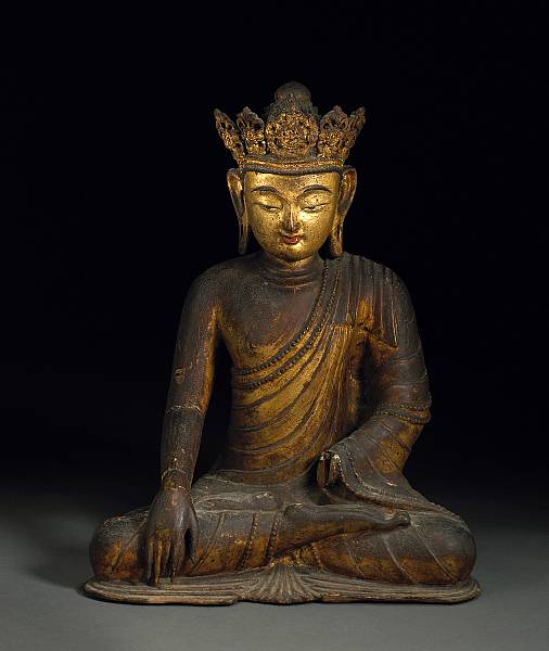 Appraisal: A gilt wood seated figure of a crowned Shakyamuni Buddha