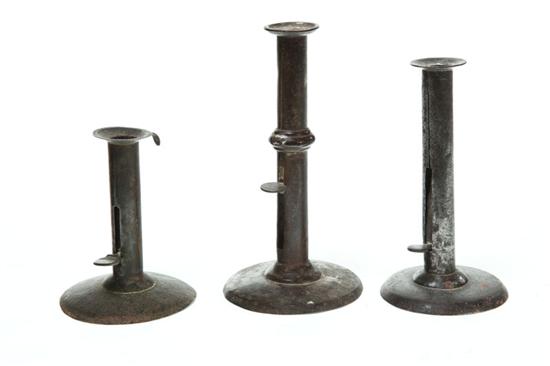 Appraisal: THREE HOGSCRAPER CANDLESTICKS American mid th century One has a