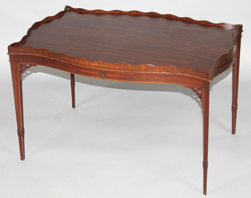 Appraisal: A thC mahogany coffee table with galleried shaped outline on