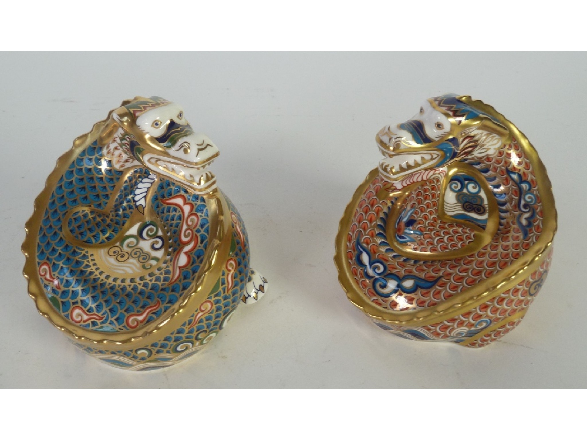 Appraisal: A PAIR ROYAL CROWN DERBY CHINA LIMITED EDITION PAPERWEIGHTS DRAGON