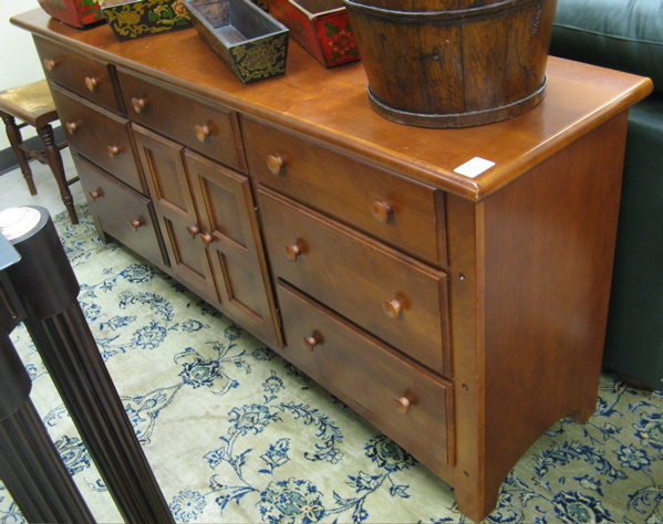 Appraisal: LONG BUREAU American country furniture design with cherry finish the