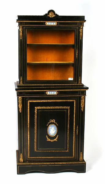 Appraisal: A Napoleon III ebonized cabinet with inset bisque porcelain plaques