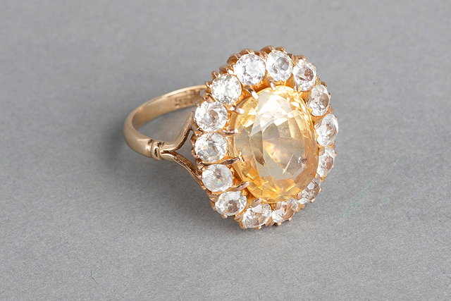 Appraisal: A CITRINE AND WHITE SAPPHIRE SET DRESS RING claw set