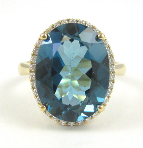 Appraisal: BLUE TOPAZ AND FOURTEEN KARAT GOLD RING with round-cut diamonds