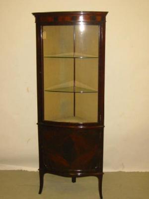 Appraisal: A MAHOGANY CORNER DISPLAY CABINET of bowed form with moulded