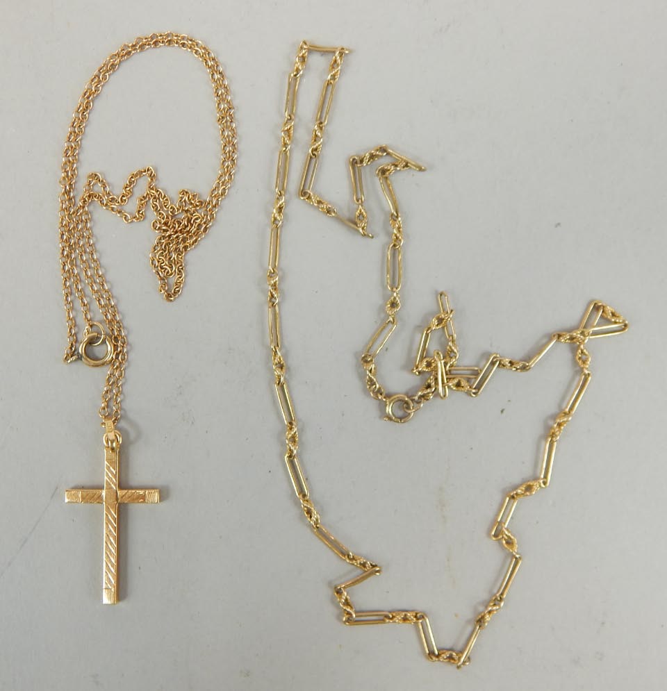 Appraisal: A ct gold crucifix and fine chain and a bar