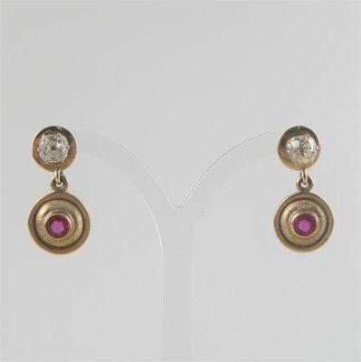 Appraisal: A pair of diamond and ruby drop earrings the circular