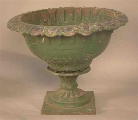 Appraisal: GREEN-PAINTED CAST IRON URN cast as a footed spreading circular