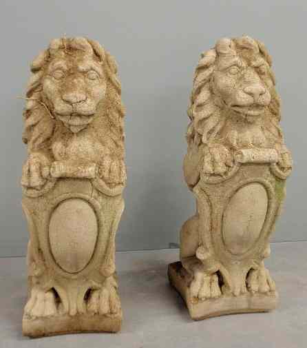 Appraisal: Pair of cast stone English style seated lions c each