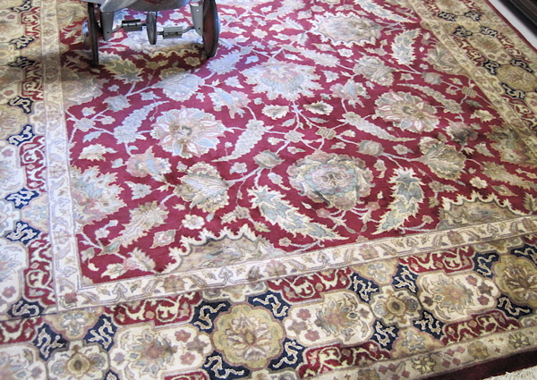 Appraisal: HAND KNOTTED ORIENTAL CARPET Indo-Persian overall foliate decorated madder red