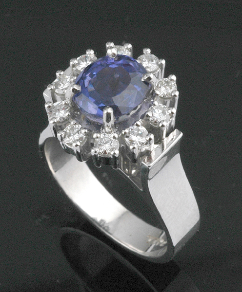 Appraisal: A PURPLE SAPPHIRE AND DIAMOND CLUSTER RING Centrally set with