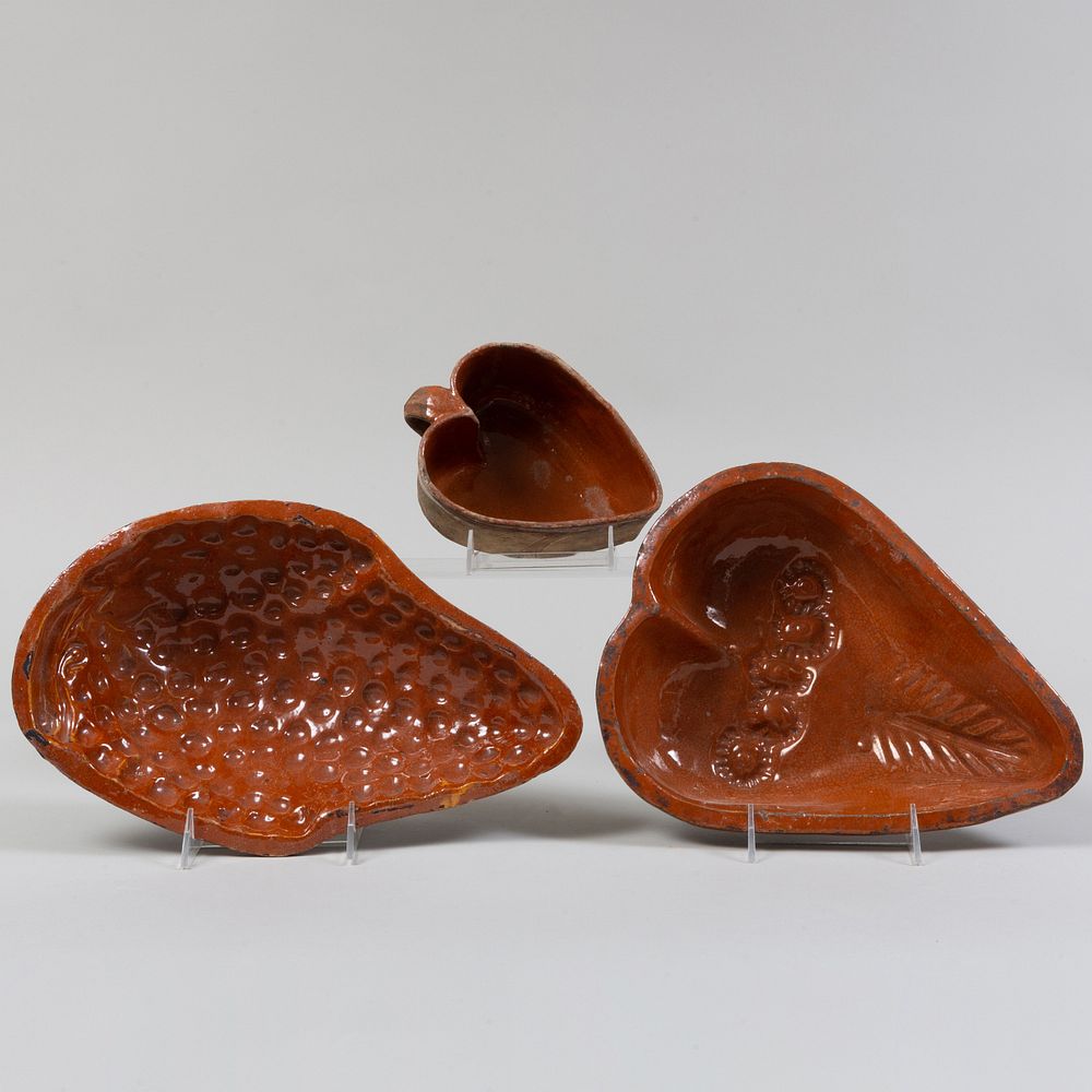 Appraisal: Three French Redware Pottery Molds Comprising A fruit form mold