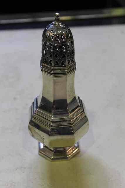 Appraisal: A GEORGIAN STYLE SILVER CASTER of octagonal baluster form with