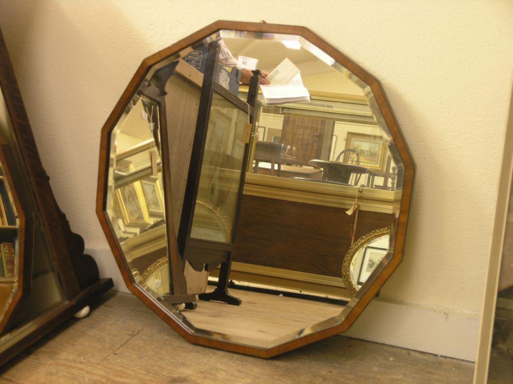 Appraisal: A walnut framed mirror duo-decagonal shape with bevelled plate ft