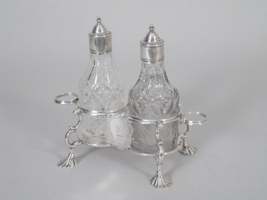 Appraisal: A George III Vinegar Bottle Stand having leafage scroll handle