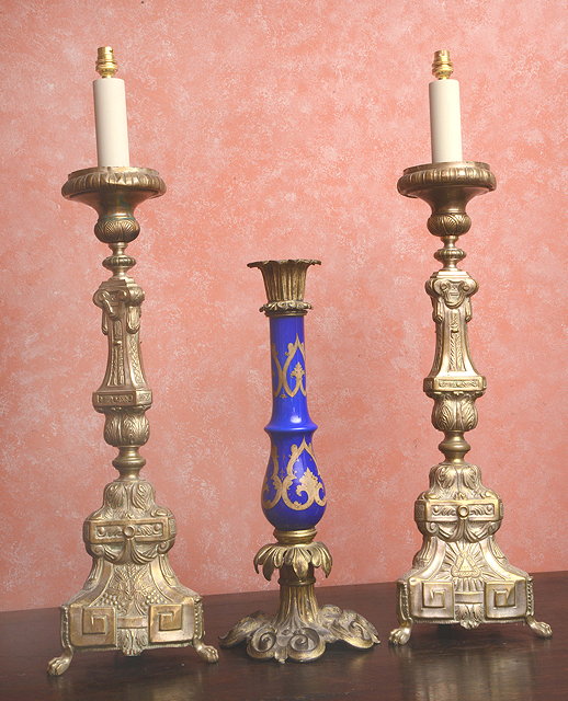 Appraisal: A PAIR OF CONTINENTAL PRESSED BRASS CANDLESTICKS of classical triangular