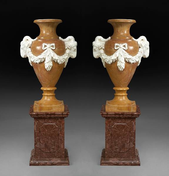 Appraisal: A pair of Neoclassical style carved marble urns on pedestals