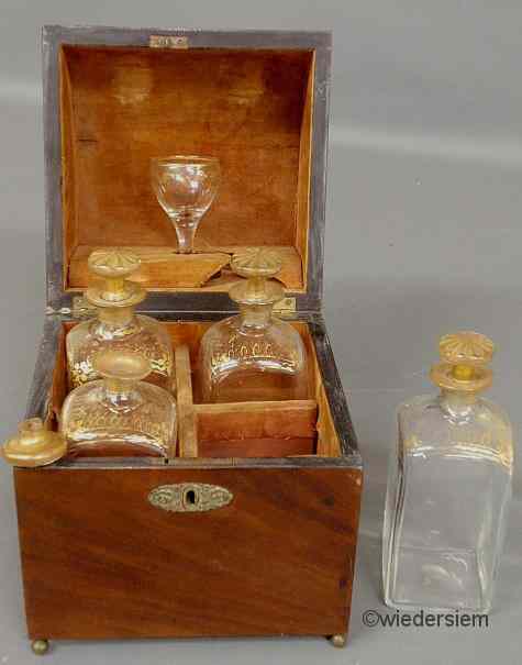 Appraisal: English mahogany cased decanter set th c with four bottles