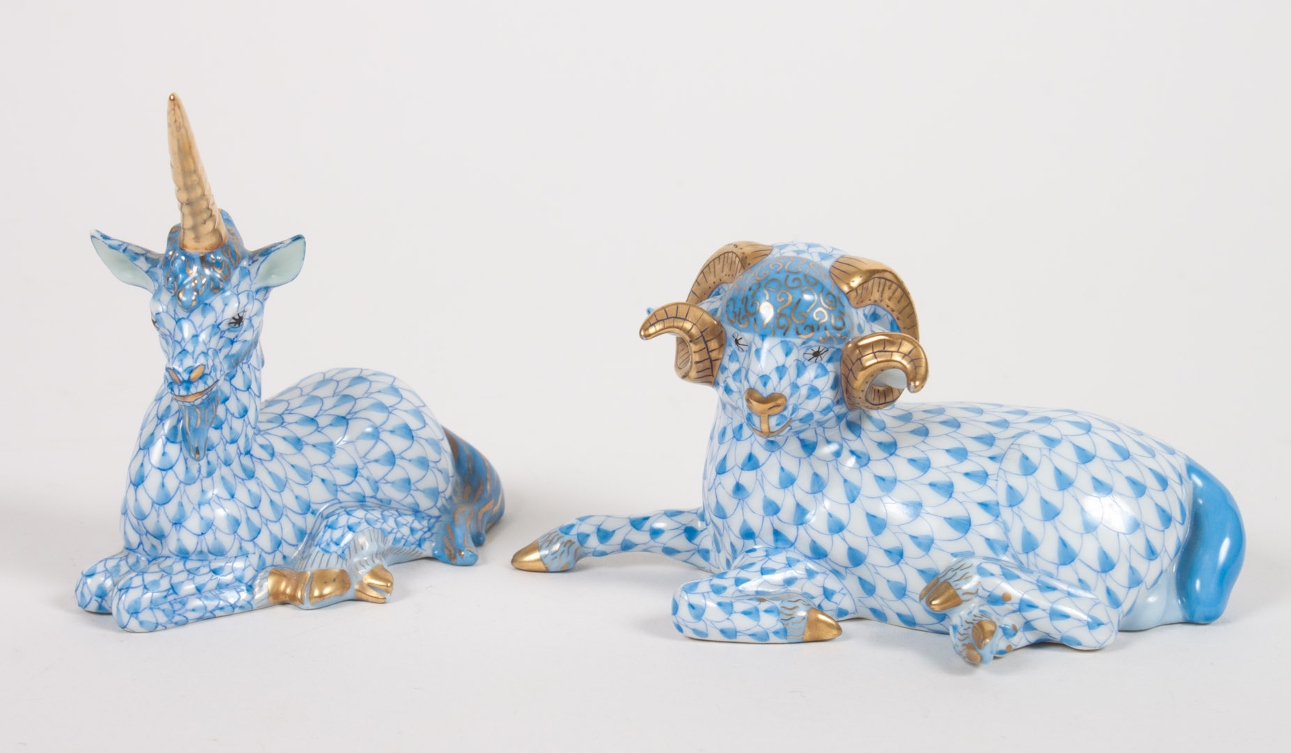 Appraisal: Herend porcelain ram and unicorn blue fishnet pattern parcel-gilt horns