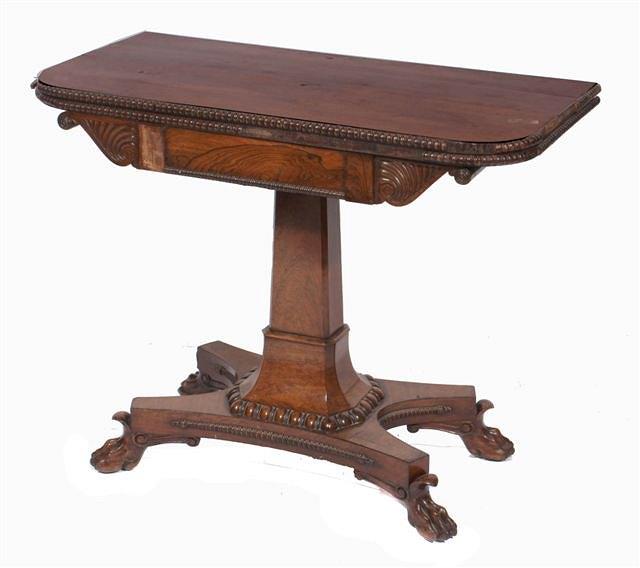 Appraisal: A Regency mahogany fold over card table with carved scrolling