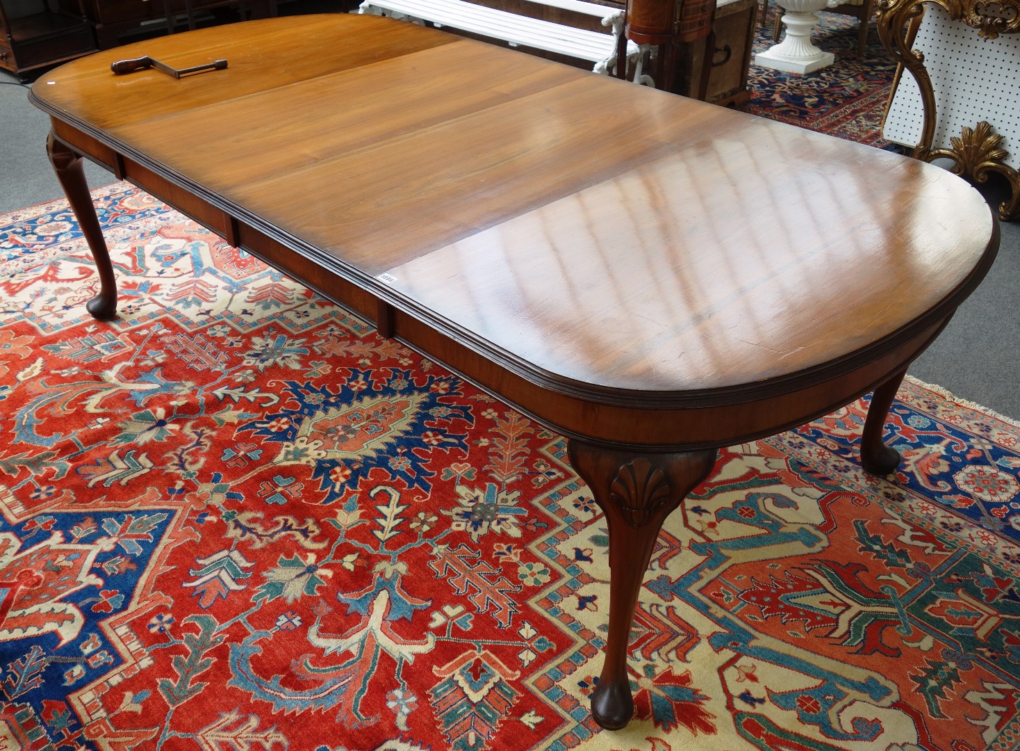 Appraisal: A mid th century walnut extending dining table on shell