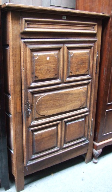 Appraisal: A th century Continental oak hall cupboard with single multipanel