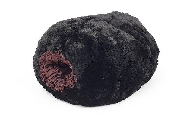 Appraisal: A black fur muff with brown silk lining ruched detailing