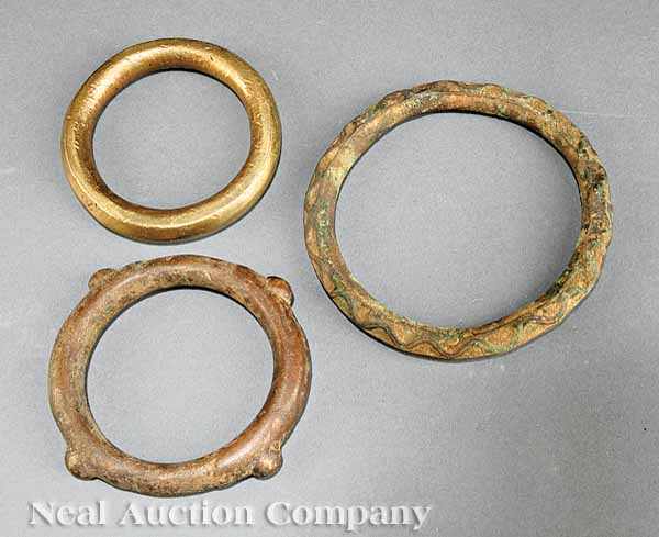 Appraisal: A Group of Three African Bronze and Brass Bracelets and