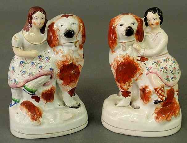 Appraisal: Pair of th c Staffordshire figures of children seated on