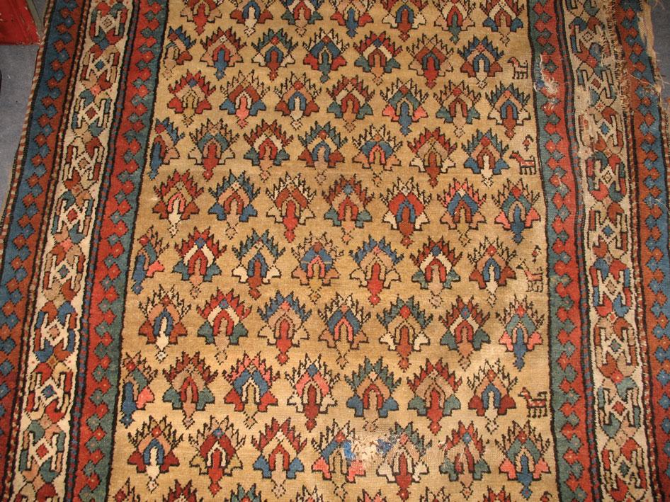 Appraisal: A CAUCASIAN TRIBAL RUG the pale beige ground central panel