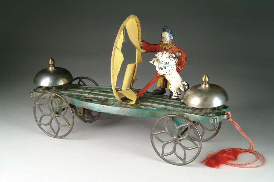 Appraisal: CLOWN WITH JUMPING DOG BELL TOY Manufactured by The Gong