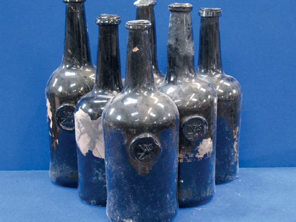 Appraisal: A COLLECTION OF SIX EARLY GREEN GLASS WINE BOTTLES including