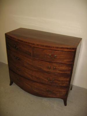 Appraisal: A GEORGE III MAHOGANY CHEST of bowed form crossbanded with