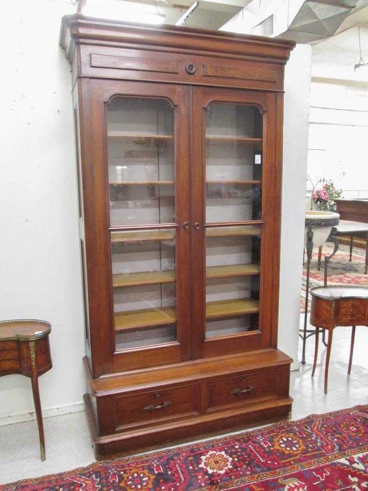 Appraisal: A VICTORIAN WALNUT CABINET BOOKCASE American c a tall double-door