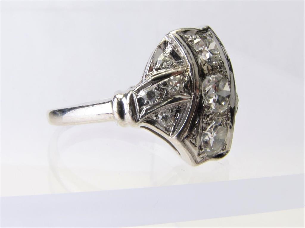 Appraisal: An antique K white gold ring with three center diamonds