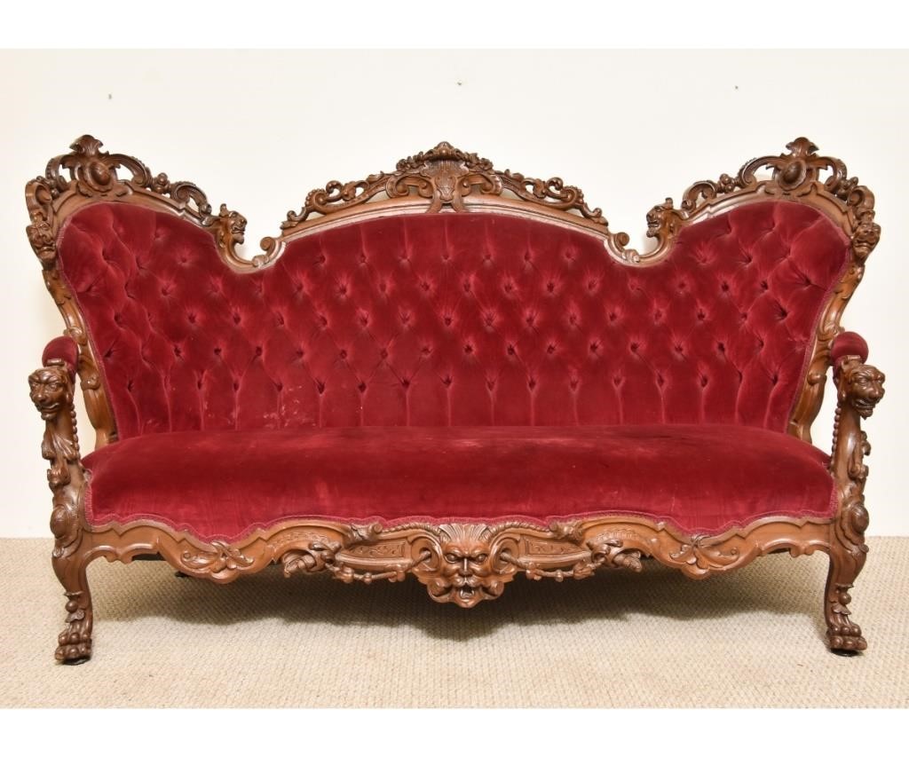 Appraisal: Victorian walnut sofa circa with floral and grotesque head carvings