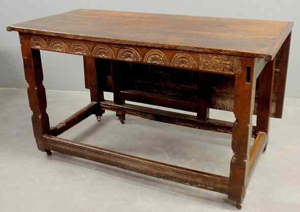 Appraisal: Jacobean oak center hall table with breadboard ends carved frieze