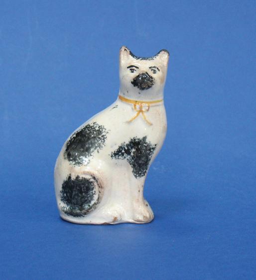 Appraisal: A TH CENTURY STAFFORDSHIRE FLATBACK MODEL OF A CAT with