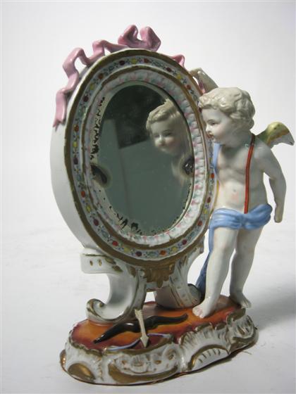 Appraisal: Sitzendorf porcelain table mirror early th century Modeled as cupid