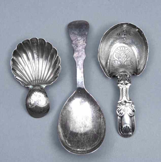 Appraisal: A GEORGE III SILVER CADDY SPOON with engraved horseshoe shaped