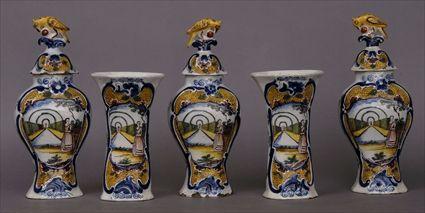 Appraisal: DUTCH DELFT POLYCHROME FIVE-PIECE GARNITURE Comprising baluster-form vases and covers