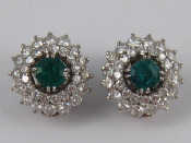 Appraisal: A pair of white metal tests carat gold emerald and