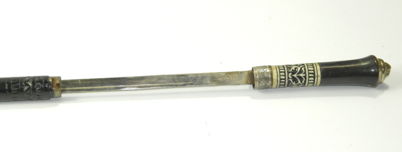 Appraisal: An Indian ebony sword stick the white metal knop cast